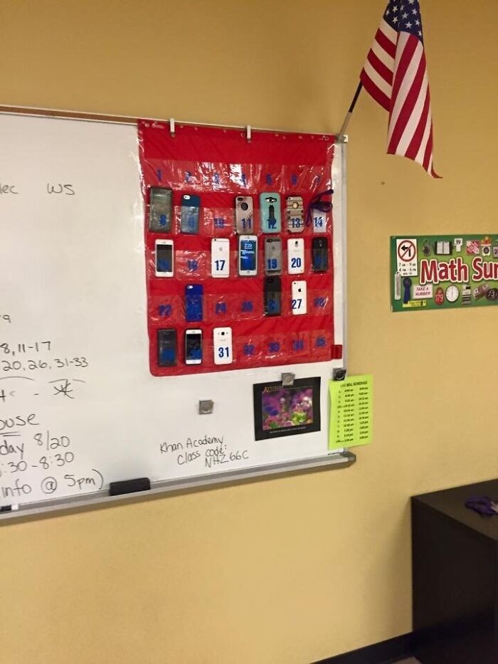 Classroom whiteboard with a humorously organized phone holder pouch for funny teachers showing creative solutions.