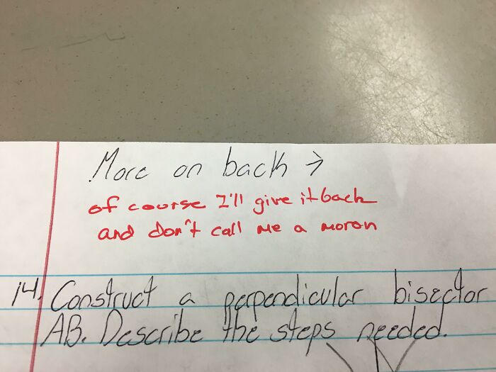 Funny teacher's red ink note on student paper, showing humor and personality in classroom interaction.