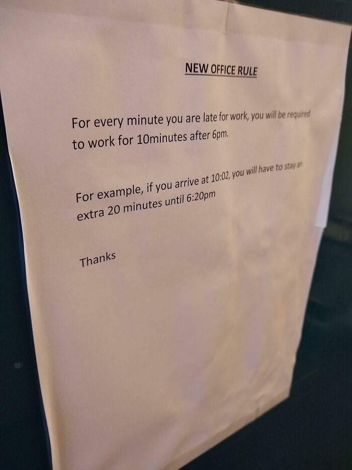 Office sign showing a new rule requiring extra work time for employees who are late, a reason people hate their boss.