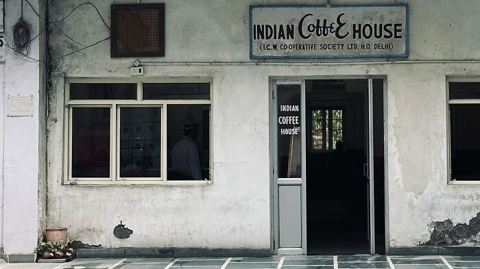 Old Indian coffee house exterior with windows and door, showcasing street photography capturing humanity in its purest form.