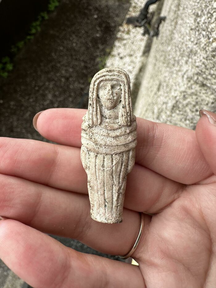 Small ancient figurine held in hand, one of the curious things people discovered and had no idea what they were.