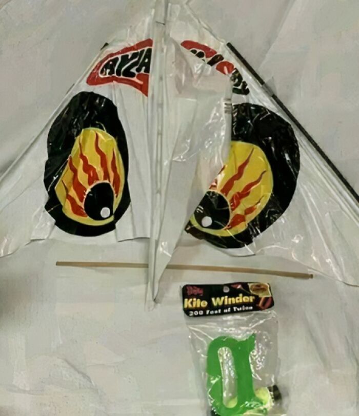 Colorful vintage kite with flame design and a 200-foot kite winder, evoking nostalgic memories of old age.