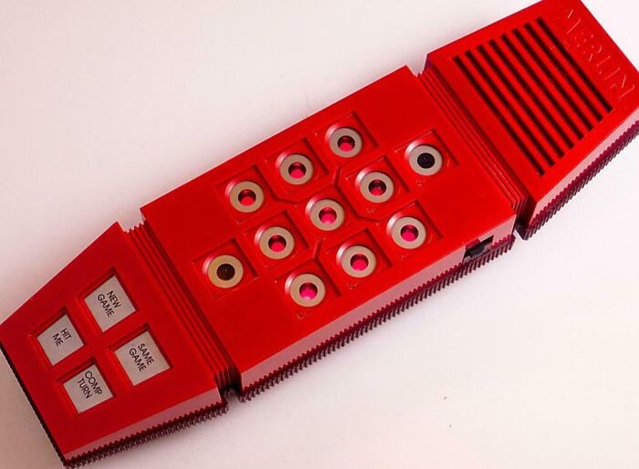 Vintage red electronic handheld game with buttons, evoking nostalgia and memories of old age for many people.