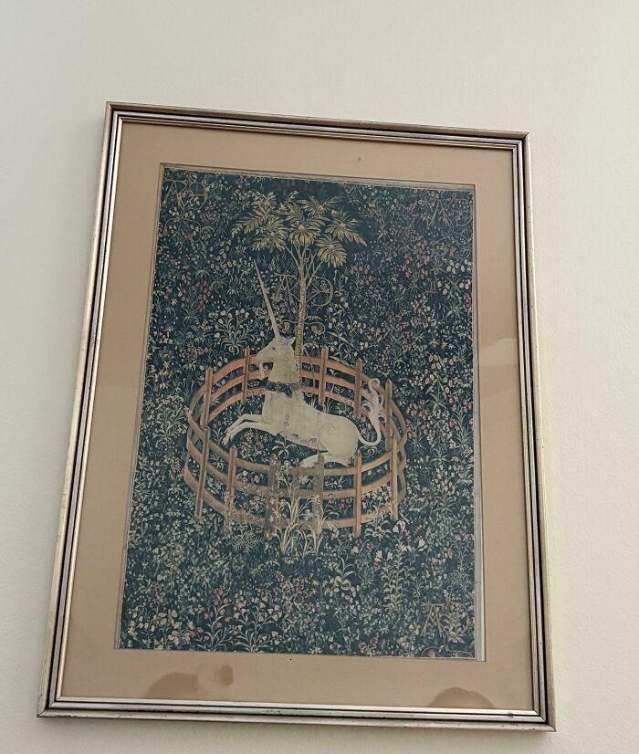 Framed vintage tapestry art of a unicorn in a floral garden, a unique thrift store find feeling like a pot of gold.