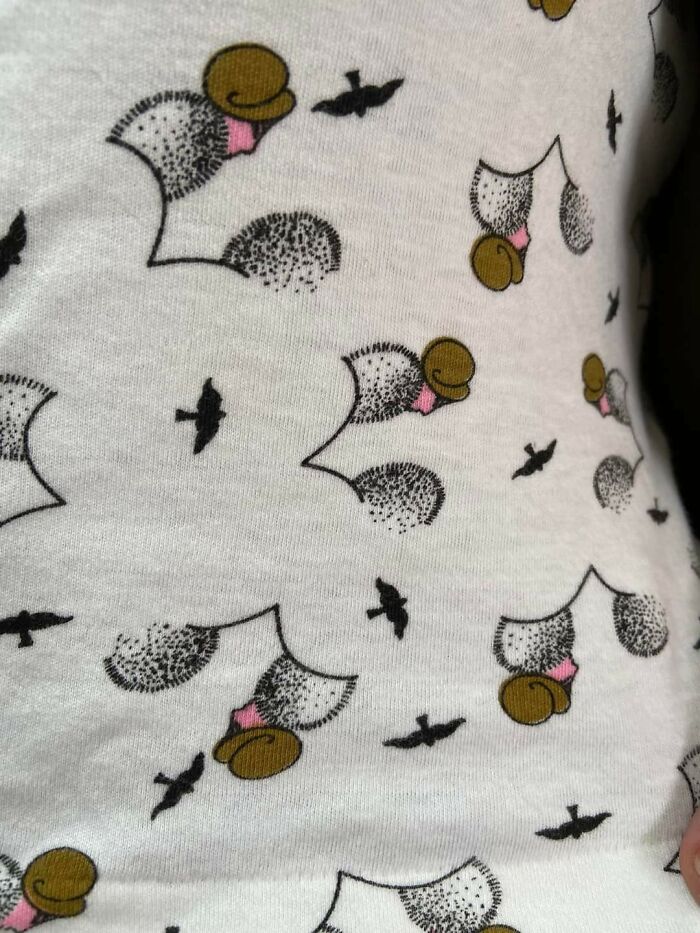 White fabric with a curious pattern of ducks and small black birds people discovered not knowing what they were.