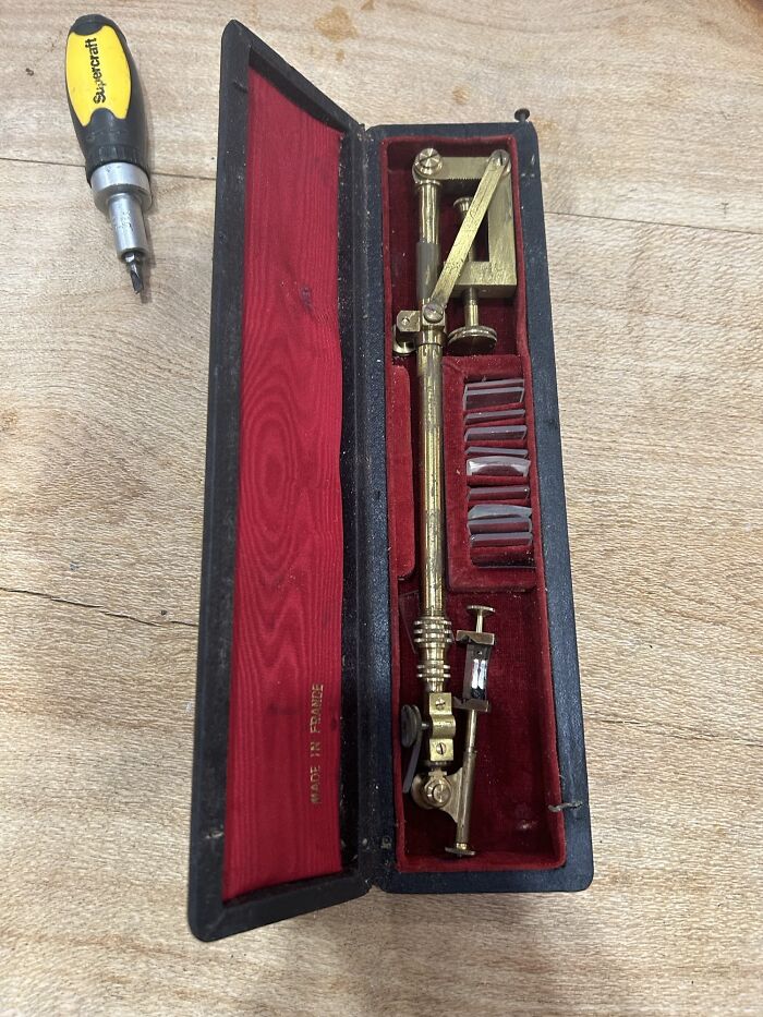 Vintage brass optical instrument with lenses in a red velvet case, one of the curious things people discovered unknown.