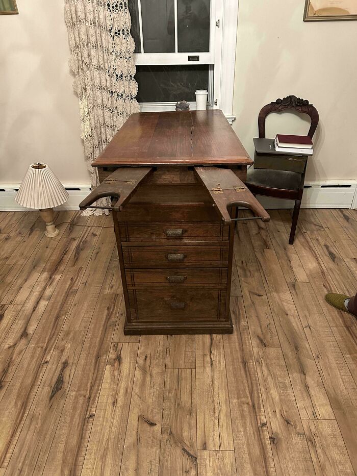 Antique wooden desk with hidden extendable armrests, one of the curious things people discovered and had no idea what they were.
