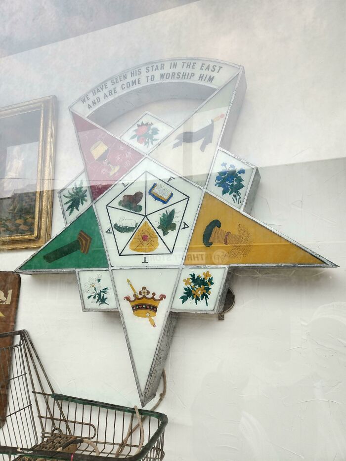 Curious vintage star-shaped display with symbols and text, a curious thing people discovered without knowing its purpose.