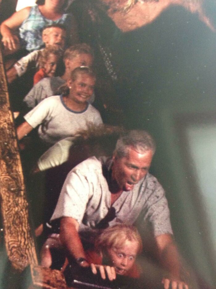 Family with kids on a log flume ride capturing one of the best photos people brought home after a trip to an amusement park