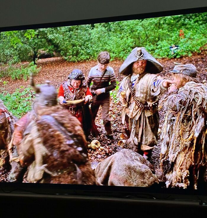 Group of people in rustic costumes in a forest setting, evoking nostalgic memories of old age and past adventures.