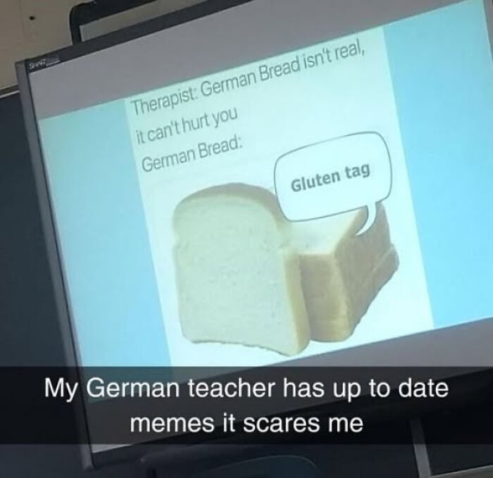 Slide on a classroom screen shows a funny German bread meme with a teacher’s humorous sense of humor in class.