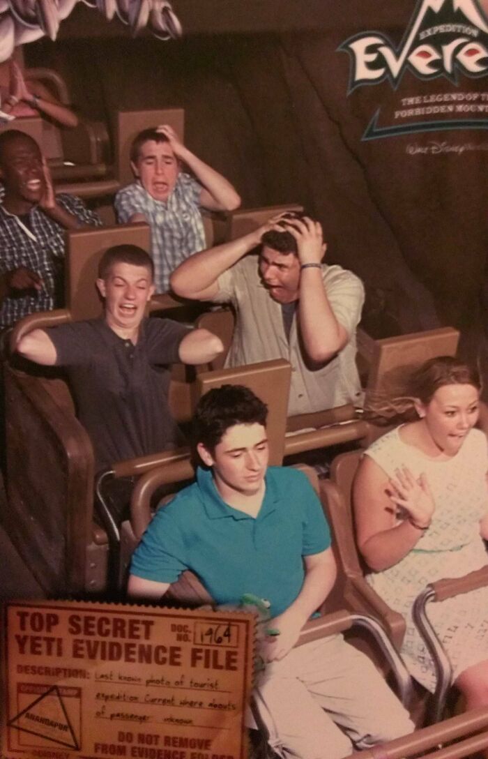 Group of people showing mixed reactions on a thrill ride captured in one of the best photos from an amusement park trip.
