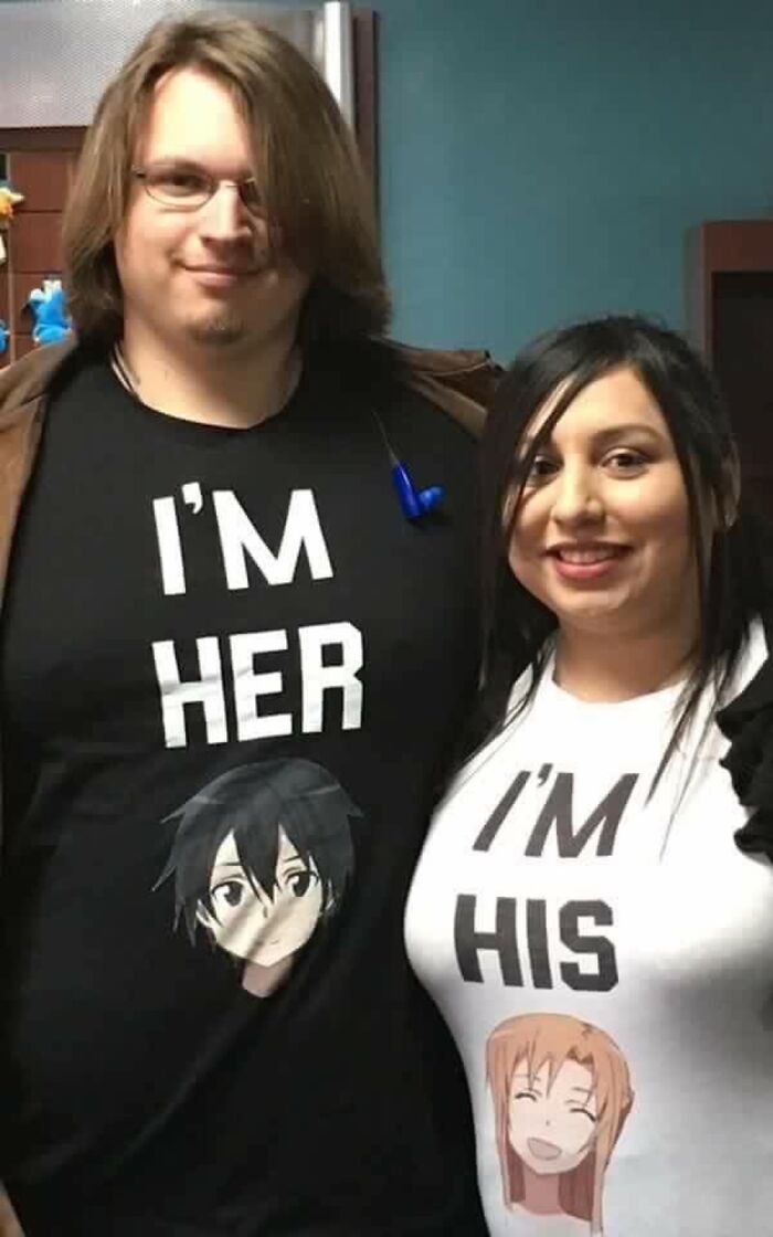Couple wearing matching anime-themed shirts with phrases I'm Her and I'm His, a cringe-worthy but wholesome post.