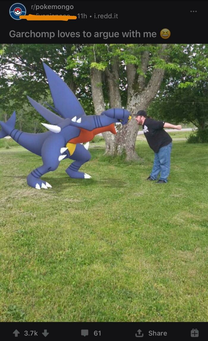 Man leaning towards a Garchomp in an augmented reality game, capturing a cringe-worthy but wholesome moment outdoors.