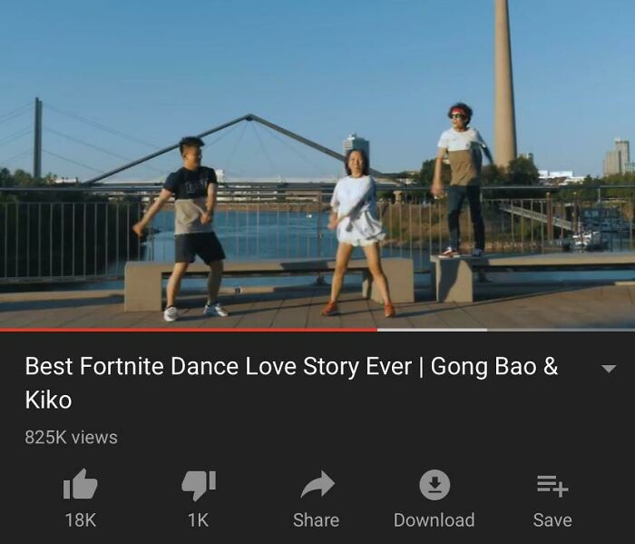 Three people dancing outdoors by a river with a bridge and tower in the background, showing wholesome and cringe-worthy vibes.