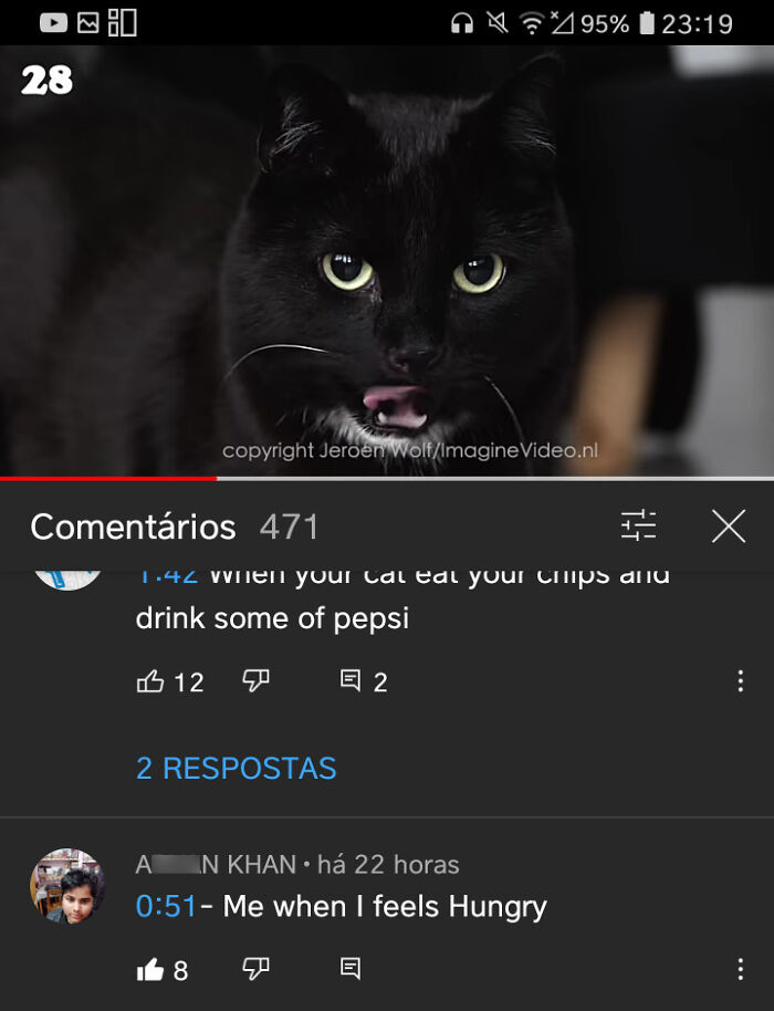 Black cat licking its lips in a video with user comments, showcasing cringe-worthy but wholesome moments online.