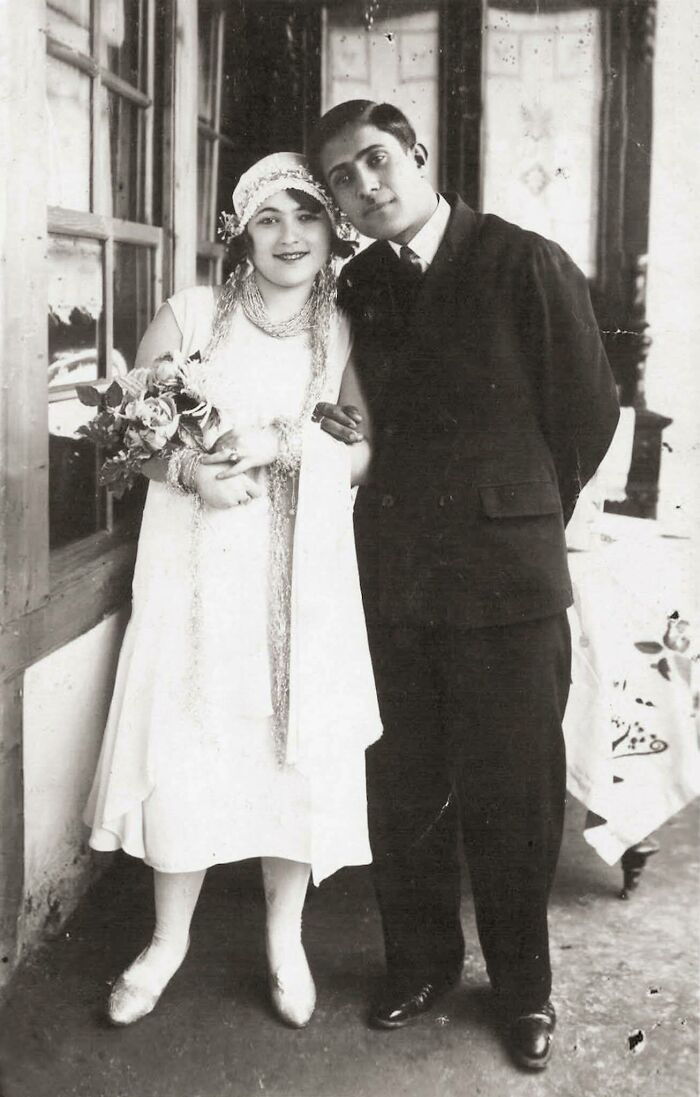 Vintage black and white photo of a couple posing indoors, showcasing people’s lives from a different time period.