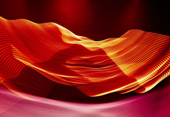 Aerial color photography captures vibrant, flowing patterns of light and texture revealing Earth's hidden natural designs.