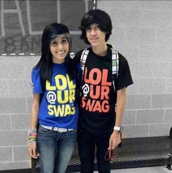 Two teenagers wearing matching LOL @ UR SWAG shirts smiling together, a cringe-worthy but wholesome moment captured.
