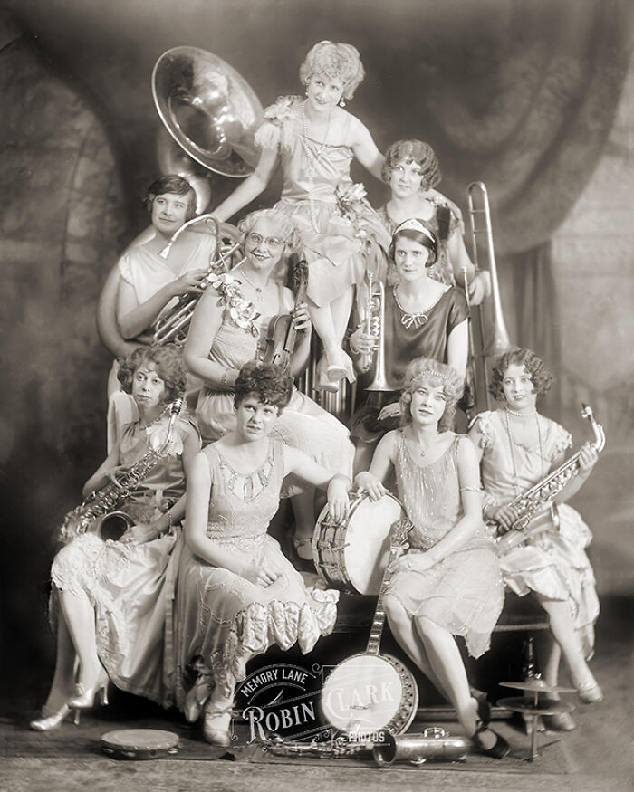 Vintage photo of musicians from a different time posing with instruments, showcasing old photos of people’s lives.