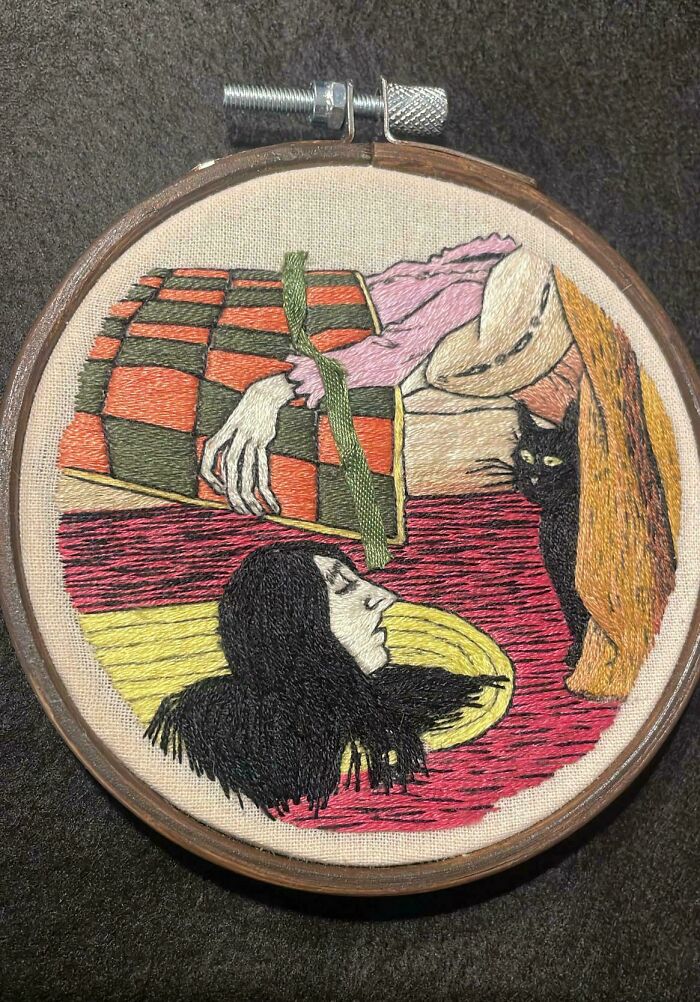 An artistic embroidery creation depicting a stylized figure with a black cat, perfect for inspiring your hobby.