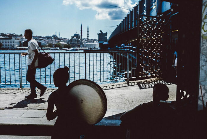 Silhouettes of people by the waterfront in Turkey, showcasing the real, candid life captured by Yusuf Aksoy.