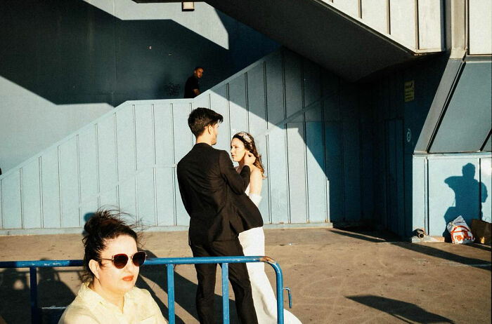 Couple in formal wear in candid street scene, showcasing the real and candid side of life in Turkey by Yusuf Aksoy.