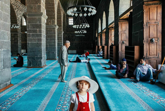 Children and adults inside a mosque, capturing candid moments of life in Turkey by Yusuf Aksoy.