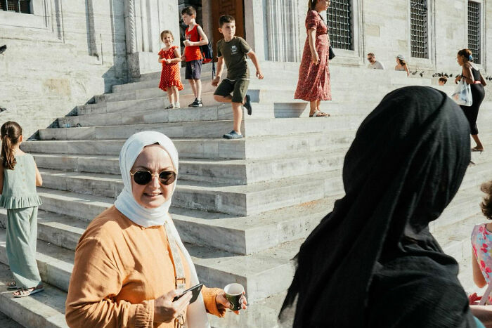 People walking and socializing on stone steps in Turkey, showcasing the real, candid side of life by Yusuf Aksoy.