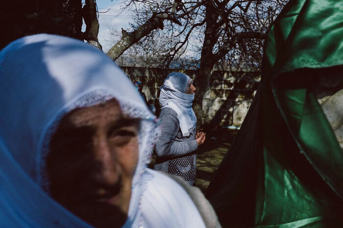 Two women wearing headscarves captured candidly in natural light, showcasing real life moments in Turkey by Yusuf Aksoy.