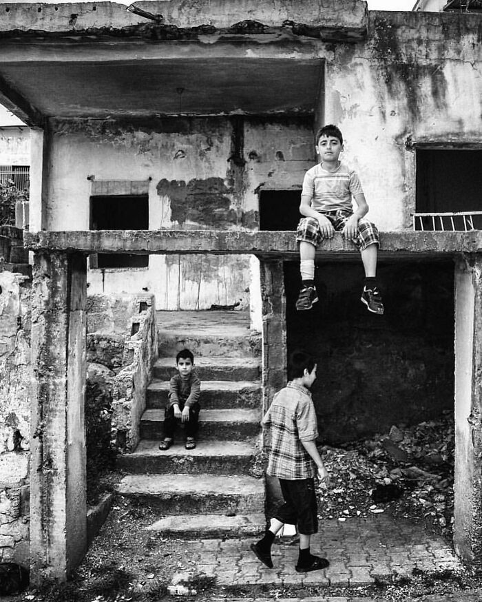 Black and white photo of children in a worn building, showcasing the real candid side of life in Turkey.