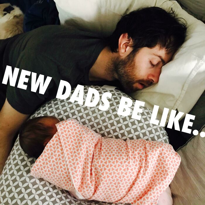 New dad sleeping next to swaddled newborn on patterned pillow showing funny differences between moms and dads.