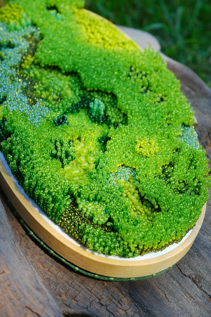 A vibrant green embroidery creation, resembling a miniature mossy landscape, inspiring new hobby ideas.