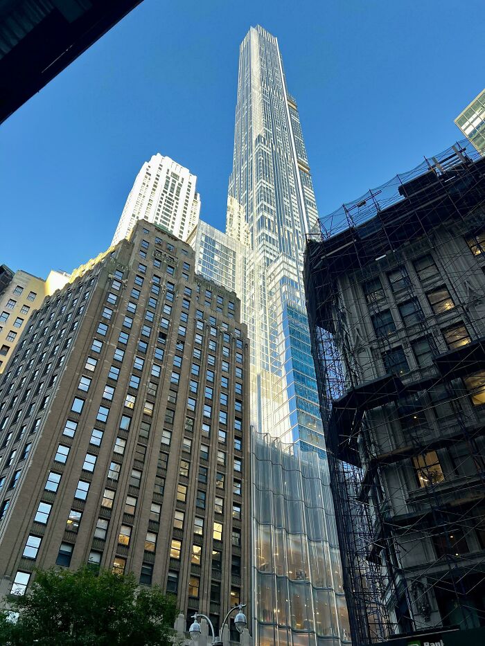 Looking up at extremely large things, towering skyscrapers, creating a sense of scary and eerie urban grandeur.