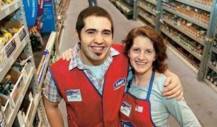 Two smiling employees in a hardware store aisle showing heartwarming stories of kindness and positivity at work.