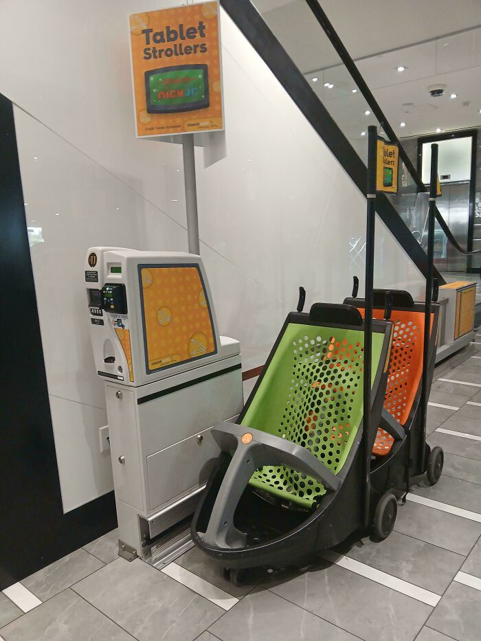 Tablet strollers for children in a mall setting reflecting real-life dystopian scenes in the US with modern convenience features.
