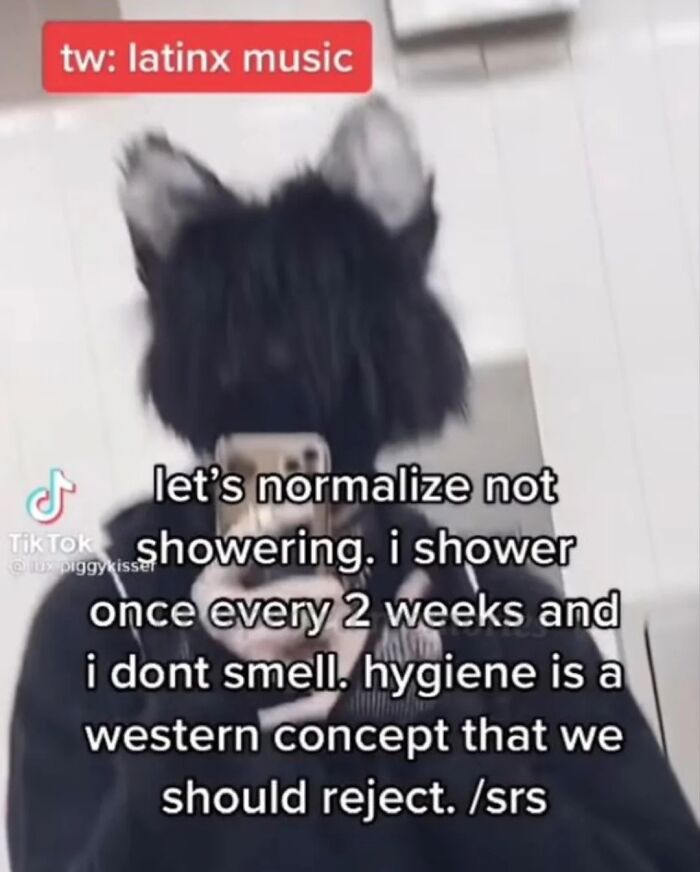 Person wearing a black dog-ear hat taking a TikTok selfie with text about hygiene and showering from TikTok screenshots.