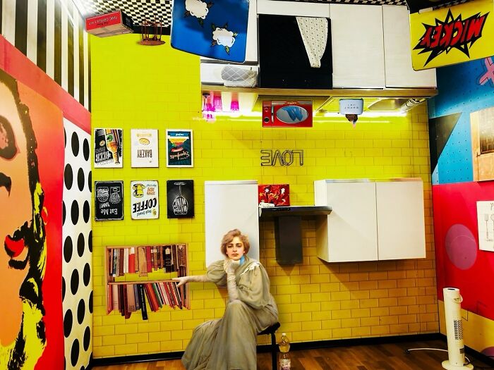 Surreal digital collage with a woman in vintage dress blending real and unreal elements in a vibrant yellow room.