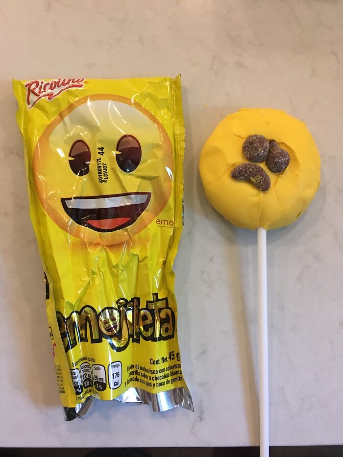 Emoji lollipop packaging versus the actual disappointing emoji candy received, illustrating purchase vs reality confusion.