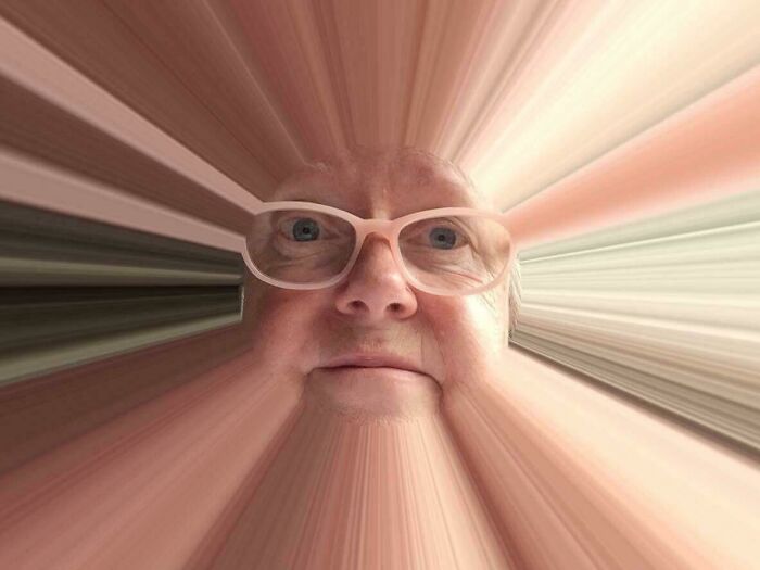 Older person wearing glasses with a humorous distorted face effect, showing a funny and wholesome parent moment.
