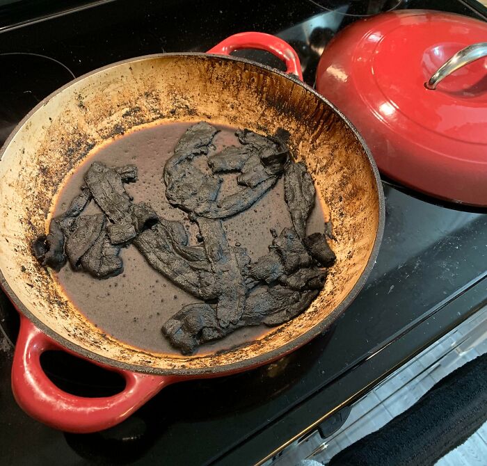 Burnt and ignored food in a pan showing the awful roommate habits people have to deal with in shared living spaces.