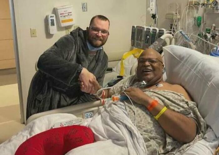 Two men sharing a heartwarming moment in a hospital room, highlighting uplifting and positive stories to cleanse negativity.