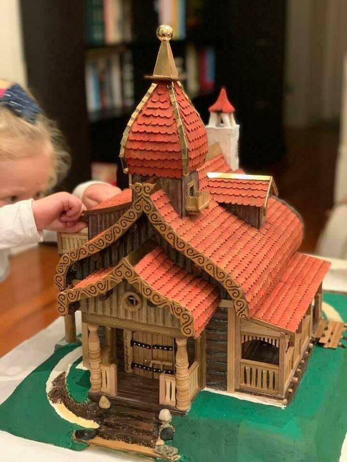 Child interacting with a detailed miniature house, showcasing funny and wholesome moments parents and kids share.