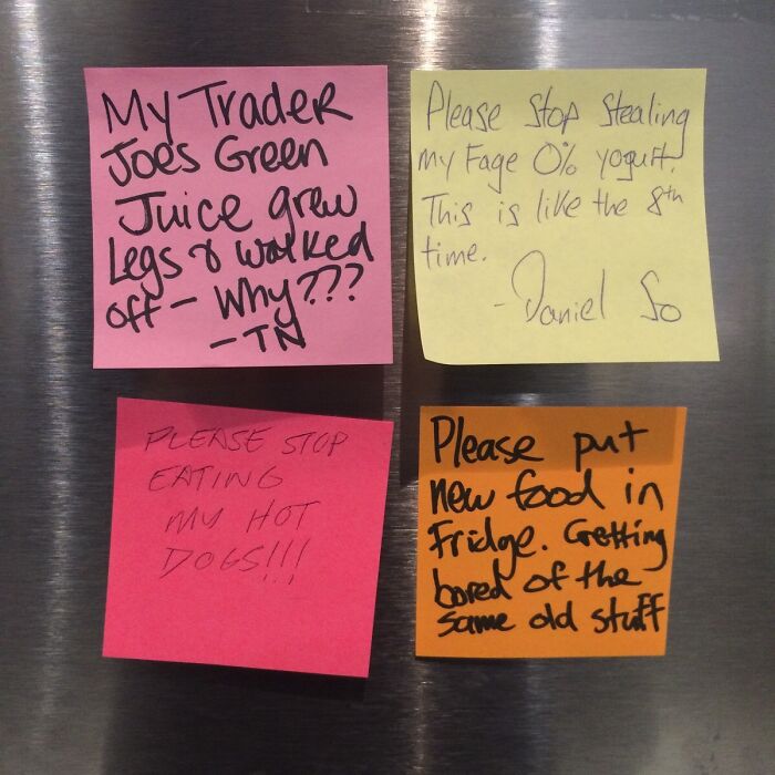 Four passive-aggressive coworker notes on colorful sticky notes about stolen food and fridge complaints on a stainless steel surface.