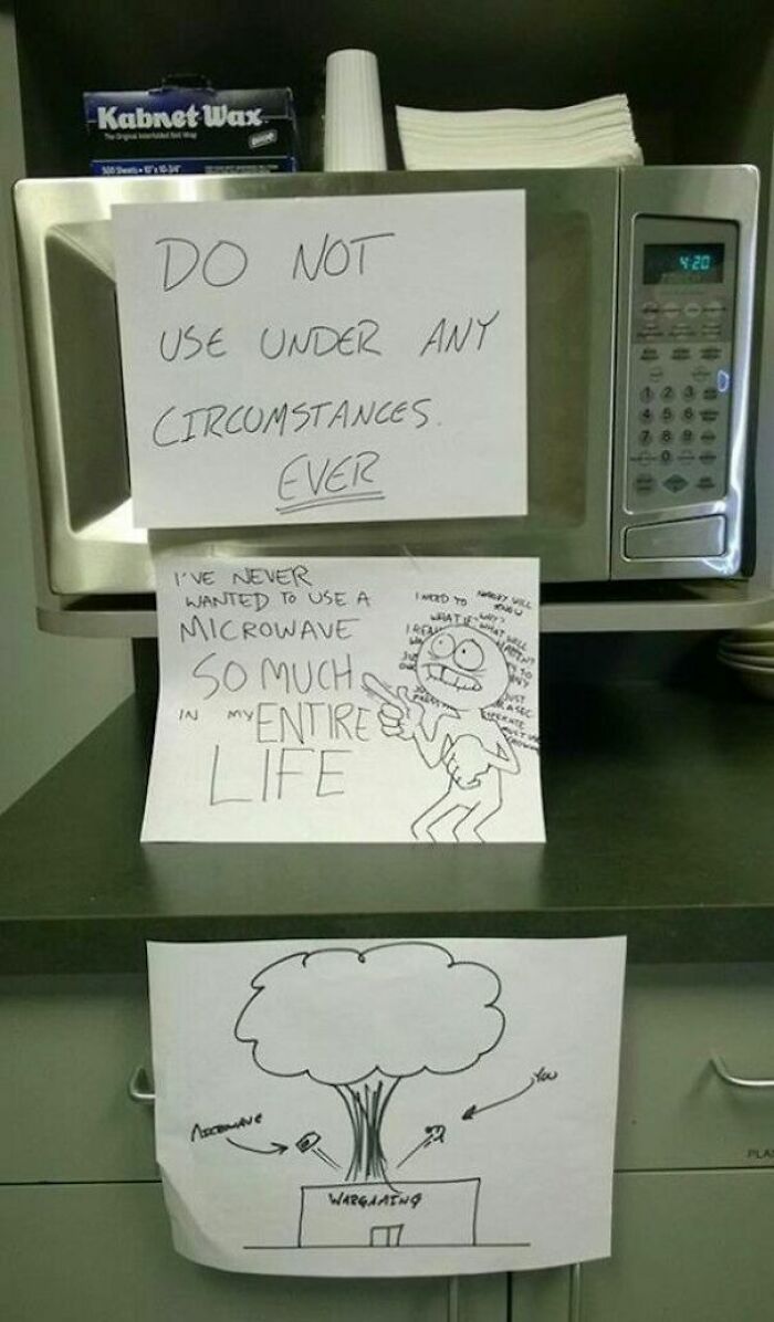 Microwave with passive-aggressive coworker notes expressing frustration and warnings clearly showing signs of breaking point humor.