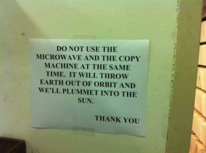 Passive-aggressive coworker note warning against using microwave and copy machine at the same time to avoid disaster.