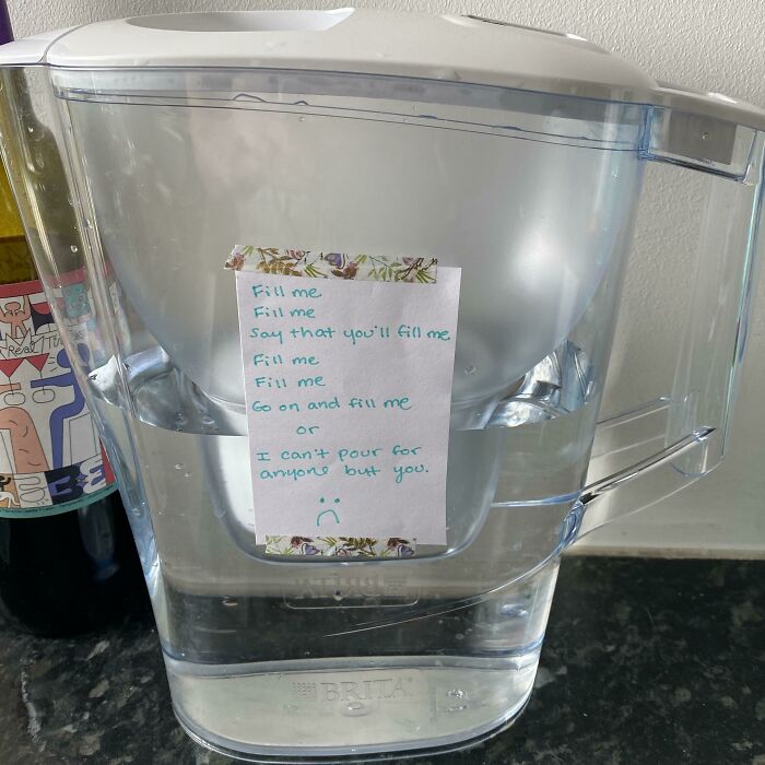 Water pitcher with a passive-aggressive note taped on, highlighting coworker frustration and passive-aggressive office humor.