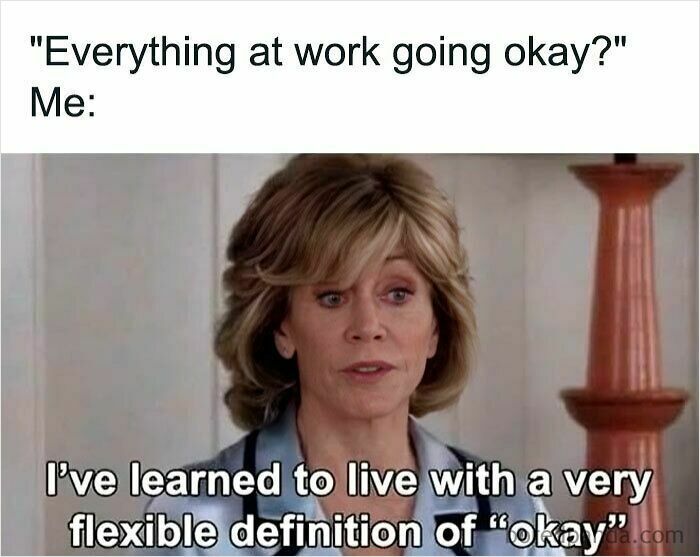 Woman with short hair in a blue shirt expressing a flexible definition of okay in a humorous work meme about work memes.