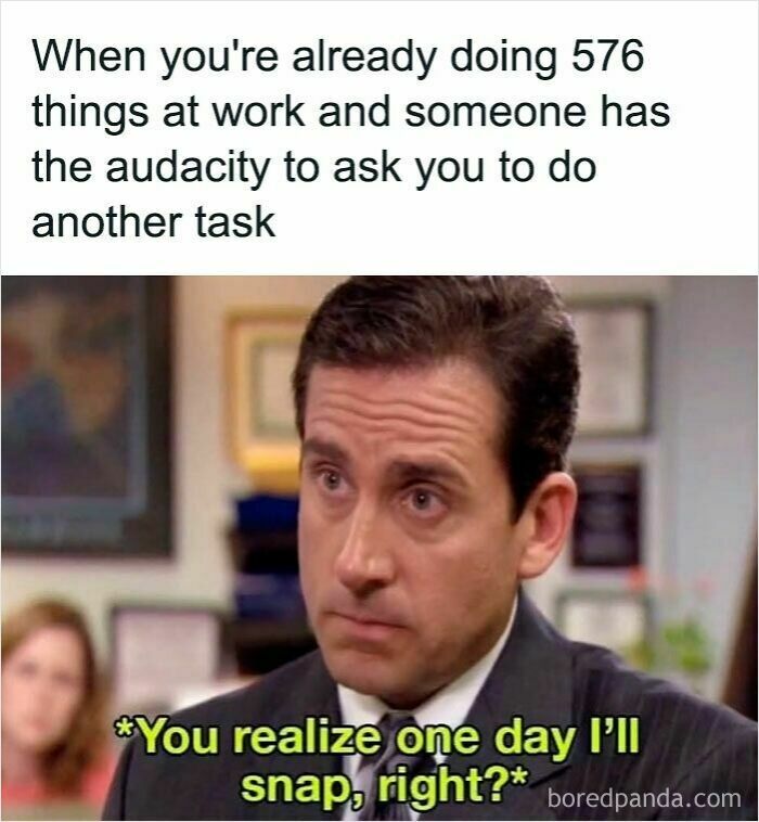Man in office with a stressed expression expressing frustration about workload in relatable work memes.