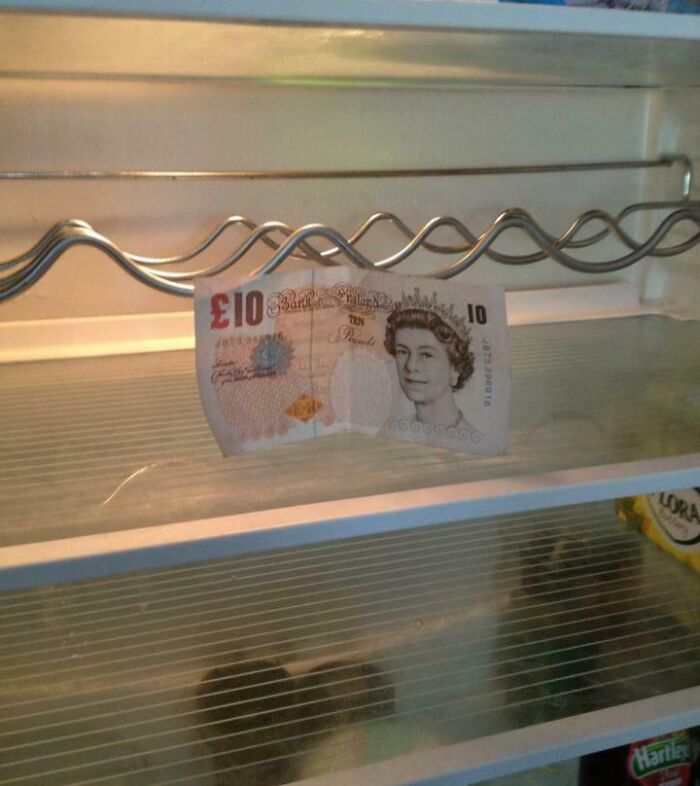 Ten-pound note placed inside an empty fridge shelf, illustrating moms being their amazing wholesome selves with humor.